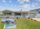 Charming single story home featuring manicured lawn, brick accents, tidy landscaping, and a quaint light-blue front door at 5512 Tropic Dr, New Port Richey, FL 34653