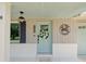 Inviting front porch with a crab theme, charming details and fresh paint at 5512 Tropic Dr, New Port Richey, FL 34653