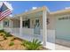 Inviting front porch with manicured landscaping and charming exterior details at 5512 Tropic Dr, New Port Richey, FL 34653