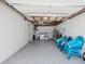 A spacious garage interior with laundry area, overhead storage, and epoxy flooring at 5512 Tropic Dr, New Port Richey, FL 34653