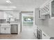 Bright, updated kitchen with stainless steel appliances and ample counter space, with a view of the pool at 5512 Tropic Dr, New Port Richey, FL 34653