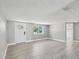Living room with wood-look flooring and lots of natural light at 5512 Tropic Dr, New Port Richey, FL 34653