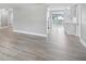 Spacious open-concept living area with luxury vinyl flooring and modern lighting at 5512 Tropic Dr, New Port Richey, FL 34653