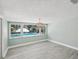 Bright living room with wood-look flooring and views of the pool and waterway at 5512 Tropic Dr, New Port Richey, FL 34653