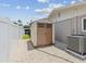 Backyard shed with double doors, gravel ground cover, and adjacent air conditioning unit at 5512 Tropic Dr, New Port Richey, FL 34653