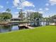 Beautiful waterfront property with a dock and lush green lawn, perfect for outdoor enjoyment at 5512 Tropic Dr, New Port Richey, FL 34653
