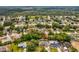 Aerial view of the property in a neighborhood with mature trees at 6076 Shiprock Ave, Spring Hill, FL 34608