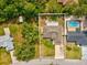 Aerial view of property showing home, deck, fenced yard and proximity to neighborhood pool at 6076 Shiprock Ave, Spring Hill, FL 34608