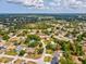 Expansive aerial view of a single Gathering residence in a residential neighborhood with mature landscaping at 6076 Shiprock Ave, Spring Hill, FL 34608