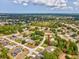 Wide aerial view of a neighborhood featuring single Gathering residences with mature trees and green spaces at 6076 Shiprock Ave, Spring Hill, FL 34608