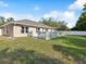 Well-maintained backyard with a wooden deck and view of the home's exterior at 6076 Shiprock Ave, Spring Hill, FL 34608