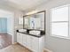 Bathroom features a double sink vanity with dark countertops and white cabinets and tile floors at 6076 Shiprock Ave, Spring Hill, FL 34608
