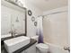 Well-lit bathroom featuring a vanity with vessel sink, decorative mirrors, and a shower-tub combo at 6076 Shiprock Ave, Spring Hill, FL 34608