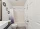 Bright bathroom featuring decorative mirrors, shower-tub combo, toilet, and bath mat at 6076 Shiprock Ave, Spring Hill, FL 34608