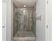 Modern bathroom showcasing a shower with glass doors and a tile surround with a modern doorless design at 6076 Shiprock Ave, Spring Hill, FL 34608