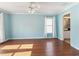 Bright bedroom featuring light blue walls, hardwood floors, a ceiling fan, and natural light from a window at 6076 Shiprock Ave, Spring Hill, FL 34608
