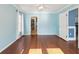 Bedroom features hardwood floors, light blue walls, ceiling fan, and access to a bathroom and closet at 6076 Shiprock Ave, Spring Hill, FL 34608