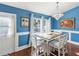 Dining room with a stylish light fixture, wood floors, and a view to the backyard at 6076 Shiprock Ave, Spring Hill, FL 34608