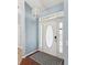 Stylish front door with decorative glass inserts and sidelights for a bright entry way at 6076 Shiprock Ave, Spring Hill, FL 34608