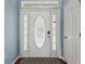 Elegant front door featuring decorative glass and sidelights, enhancing curb appeal at 6076 Shiprock Ave, Spring Hill, FL 34608
