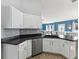 Bright kitchen featuring stainless steel appliances, white cabinets, and a view into the living area at 6076 Shiprock Ave, Spring Hill, FL 34608