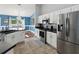 Modern kitchen featuring stainless steel appliances, white cabinets, and a spacious island at 6076 Shiprock Ave, Spring Hill, FL 34608