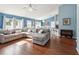 Open concept living room and dining area with hardwood floors and ample natural light at 6076 Shiprock Ave, Spring Hill, FL 34608