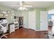 Home office featuring hardwood floors, light green walls, ceiling fan, desk and shelving at 6076 Shiprock Ave, Spring Hill, FL 34608