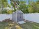 Backyard shed with concrete base and white fencing at 6076 Shiprock Ave, Spring Hill, FL 34608