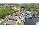 Aerial view featuring waterfront homes with boat docks and private pools, showcasing a luxurious coastal community at 6340 Spoonbill Dr, New Port Richey, FL 34652