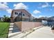 Backyard view of the two-story home, patio, and green lawn, enclosed by a black fence for added privacy at 6340 Spoonbill Dr, New Port Richey, FL 34652