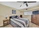Cozy bedroom featuring a ceiling fan, wood-look flooring, and a comfortable bed at 6340 Spoonbill Dr, New Port Richey, FL 34652