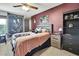 Bedroom featuring a colorful theme, ceiling fan, dresser, bed and decorations at 6340 Spoonbill Dr, New Port Richey, FL 34652