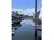 Canal view from dock with boatlift, clear skies reflecting on the water, and waterfront homes at 6340 Spoonbill Dr, New Port Richey, FL 34652