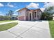 Exterior elevation of a two-story home with large driveway and manicured lawn at 6340 Spoonbill Dr, New Port Richey, FL 34652