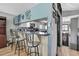 Kitchen featuring bar seating, white cabinets, and an open view into the living room at 6340 Spoonbill Dr, New Port Richey, FL 34652
