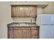 Well-equipped kitchenette featuring wooden cabinets and a mini-fridge at 6340 Spoonbill Dr, New Port Richey, FL 34652