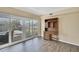 Bright living room with sliding glass doors offers pool views and wood-look flooring at 6340 Spoonbill Dr, New Port Richey, FL 34652
