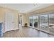 Open living room with sliding glass doors and wood-look flooring at 6340 Spoonbill Dr, New Port Richey, FL 34652