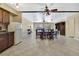 Open-concept living space featuring tile floors and ceiling fans, seamlessly connecting to dining area at 6340 Spoonbill Dr, New Port Richey, FL 34652