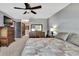 Comfortable main bedroom with ceiling fan, carpet, dresser, television and ensuite bathroom access at 6340 Spoonbill Dr, New Port Richey, FL 34652