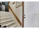 Stairway with tiled steps and wooden handrail at 6340 Spoonbill Dr, New Port Richey, FL 34652