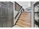 Stairway with wood steps and railing with natural light at 6340 Spoonbill Dr, New Port Richey, FL 34652