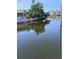 Scenic waterfront view, showcasing tranquil canal with lush greenery along the banks and a reflection of the sky at 6340 Spoonbill Dr, New Port Richey, FL 34652
