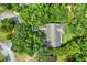 Aerial view of a home surrounded by lush greenery, showcasing its private setting and well-maintained surroundings at 642 Erin Way, Brooksville, FL 34601