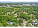 Expansive aerial view of a serene neighborhood surrounded by lush greenery and mature trees at 642 Erin Way, Brooksville, FL 34601
