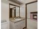 Bathroom featuring vanity with large mirror and a glimpse into the living room with fireplace at 642 Erin Way, Brooksville, FL 34601