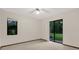 Bedroom with a sliding glass door and neutral carpeting at 642 Erin Way, Brooksville, FL 34601