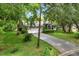 This home features a well-maintained lawn, mature trees, and a driveway leading to a two-car garage at 642 Erin Way, Brooksville, FL 34601