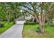 Attractive home featuring a long driveway, a well-maintained lawn, mature trees, and professionally landscaped front yard at 642 Erin Way, Brooksville, FL 34601